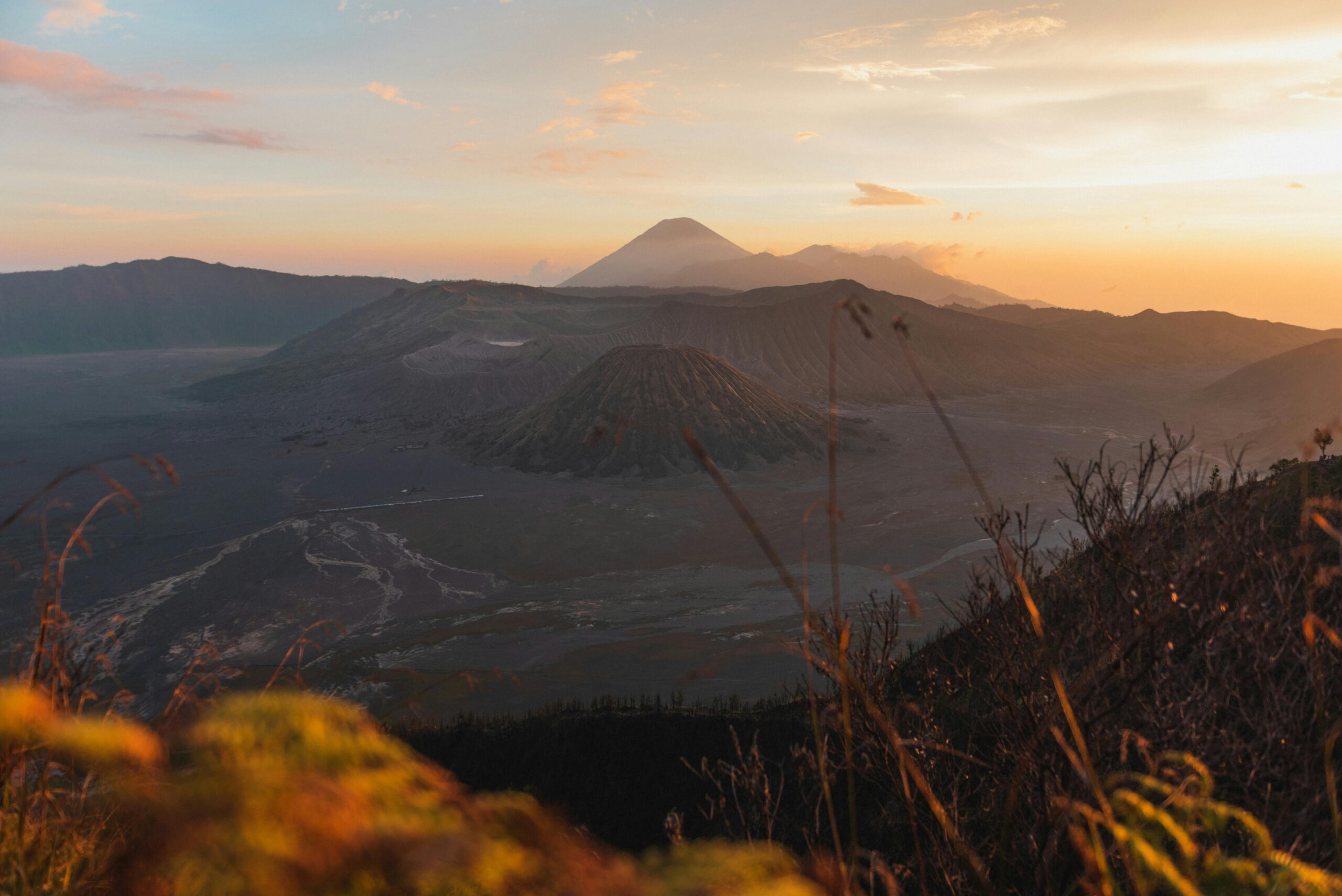 A stunning sunrise view of Mount Bromo and its surrounding landscape in Sukapura, East Java, Indonesia.